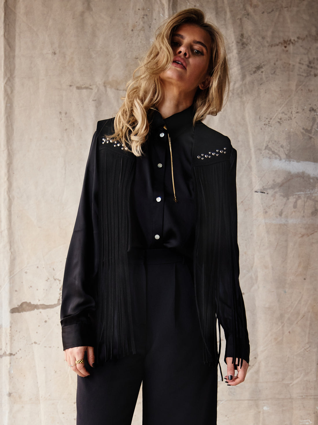 black studded fringe vest with horseshoe applique detail on  on the back