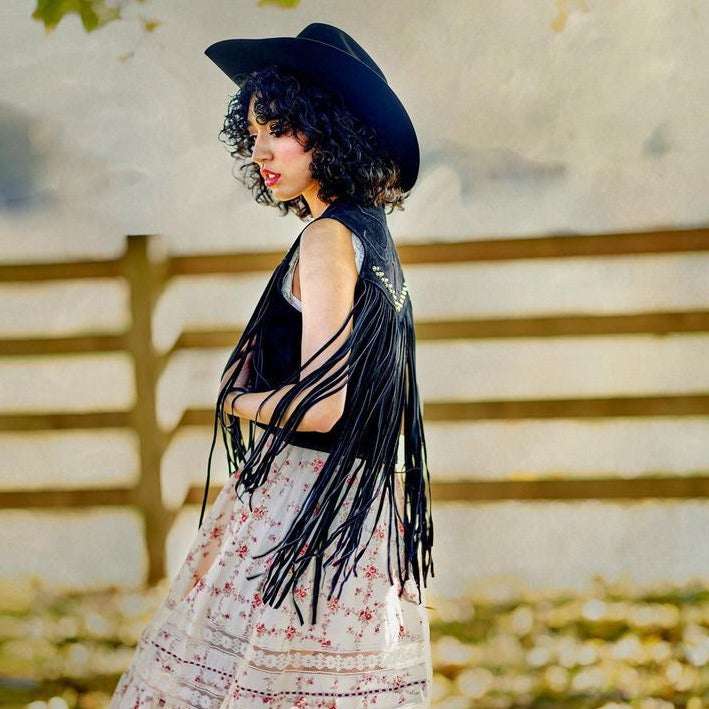 black studded fringe vest with horseshoe applique detail on  on the back